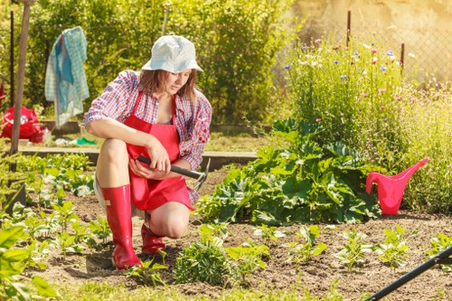 Gardener working on a lush garden in Upminster